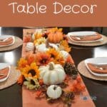 Fall table decor with an orange tablerunner.