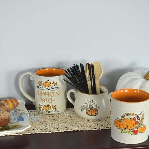 Coffee mugs on a sidebar for a hot cocoa bar.